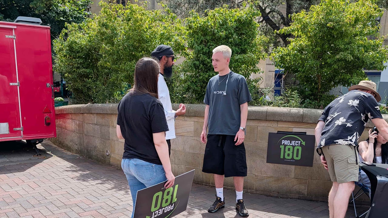 A Project 180 volunteer speaks with a participant after he completed the Movie Challenge in Bedford.